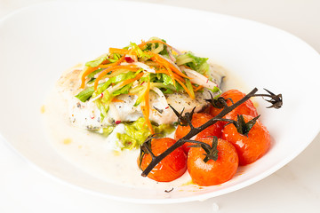 fish with avocado sauce and salad close-up