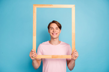Portrait of funky cheerful guy hold wooden brick frame make picture of himself wear casual style...