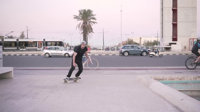 Hipster man skating in city