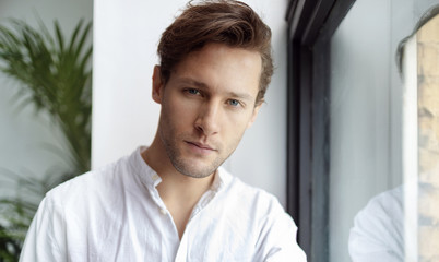 Portrait of young confident man looking at camera. Handsome milennial well-dressed good-looking attractive businessman. 