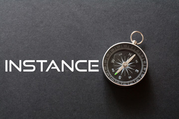 Instance word written on black background with compass