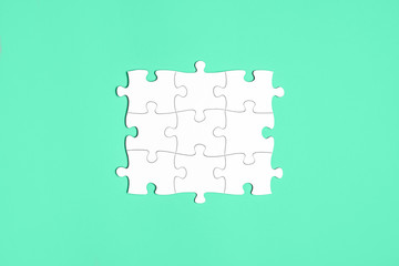 Connected white puzzle pieces isolated on aquamarine background