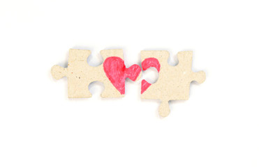Puzzle with a red heart on the white isolation background. Two disconnected halves Valentine's day stock photo with empty space for your text. For web, print, postcard, background and wallpaper 