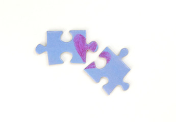 Blue puzzle with a red heart on the white isolation background. Two disconnected puzzle halves. Valentine's day stock photo with empty space for text.For web, print, postcard, background and wallpaper