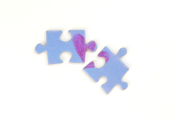 Blue puzzle with a red heart on the white isolation background. Two disconnected puzzle halves....