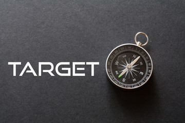 Target word written on black background with compass