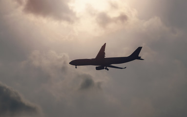 Fototapeta na wymiar airplane landing with sunset sky