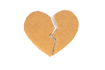 Broken cardboard heart on an isolated white background. Two halves of the heart. The concept of a broken heart, unrequited love. Valentine's Day stock photo with empty space for your space