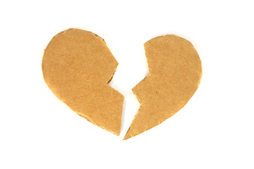 Broken cardboard heart on an isolated white background. Two halves of the heart. The concept of a broken heart, unrequited love. Valentine's Day stock photo with empty space for your space