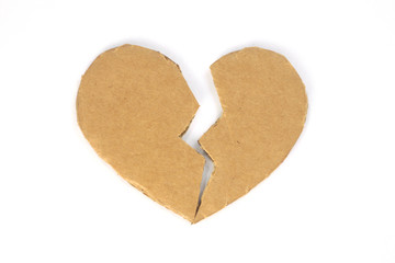 Broken cardboard heart on an isolated white background. Two halves of the heart. The concept of a broken heart, unrequited love. Valentine's Day stock photo with empty space for your space