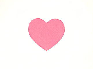 Оne pink felt heart on a white isolated background. Stock photo for the day of St. Valentine with empty space for your text. For web, print, postcards and wallpaper.