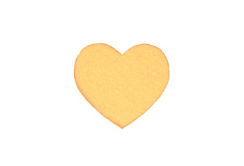 Оne felt yellow heart on a white isolated background. Stock photo for the day of St. Valentine with empty space for your text. For web, print, postcards and wallpaper.