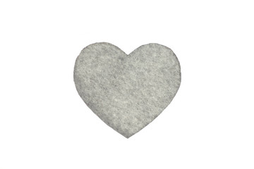 Оne gray felt heart on a white isolated background. Stock photo for the day of St. Valentine with empty space for your text. For web, print, postcards and wallpaper.