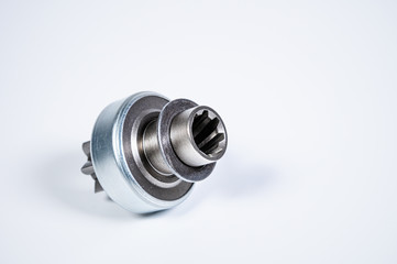 New spare parts - starter gear drive for motor starter on a gray background. Classic gear...