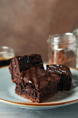 Composition with chocolate cake slices on white wood background, close up