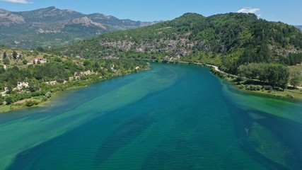Fototapeta premium Aerial view of Trebisnjica river mountainous valley, Lastva village, Bosnia and Herzegovina. Turquoise water, green hills.