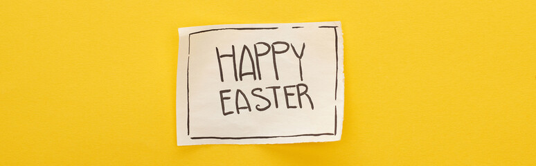 top view of greeting card with happy Easter lettering on yellow colorful background, panoramic shot