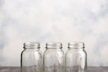Three empty clean jars with drops of water.