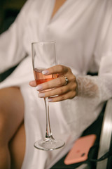 a glass of champagne in the hands of the bride