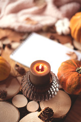 Fototapeta na wymiar Cozy autumn composition with a candle and a candlestick.