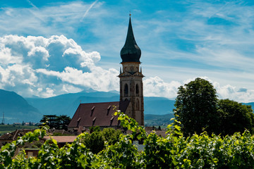 Church of Kaltern on Lake Kaltern with vineyards