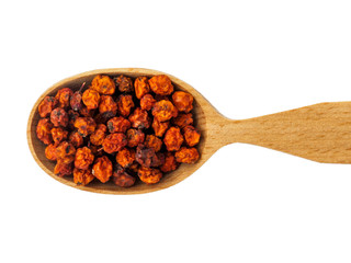 Dry red Sorbus berries in wooden spoon on white background