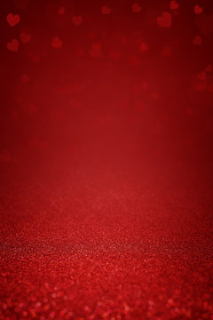 Sparkling deep red glitter background with hearts. Abstract background for Valentine's Day, love and romantic celebration. Festive banner and poster. Copy space for text.