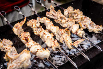 Men preparing barbecue outdoor. Male roasting shashlik on grill.