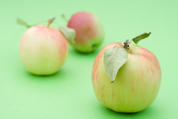 Juicy apples on green background