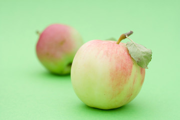 Juicy apples on green background