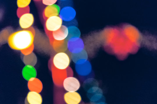 christmas lights on the streets at night. abstract blurred background toned in blue