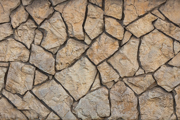 Wall of wild beautiful brown brown large stone