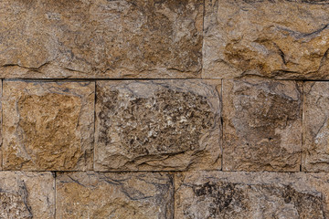 Wall of wild beautiful brown brown large stone