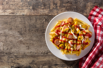 Typical Latin America Salchipapa. Sausages with fries, ketchup,mayo and mustard.Top view Copy space