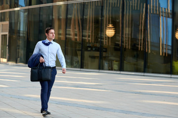 Fast walking businessman hurring to the meeting during hot wheather