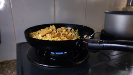 Com Chien - Delicious fried rice with egg jam ham chicken Vietnamese traditional food asian cuisine in black cast iron pan