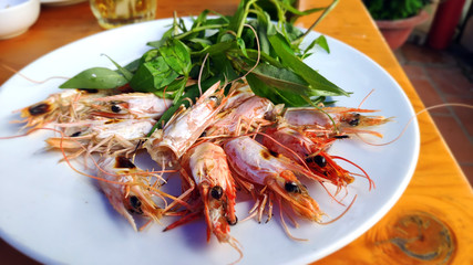 Big red shrimps Delicious king prawn boiled with head and  sweet chillies sauce green vegetable herbs on white plate Asian cuisine Thai traditional food healthy fresh seafood