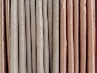 the background of the textile pattern of many colors curtains for sale in  the local store of Thailand