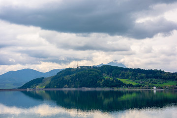 lake liptovska mara in slovakia. wondeful travel destination of high tatras mountain ridge. cloudy weather in springtime. reflection in the water