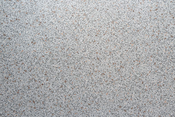 Top view gray background with small spots of different colors, marble crumb, kitchen worktops