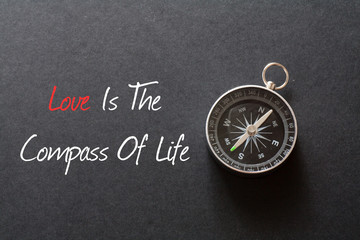 Inspirational quote : Love is the compass of life ,on black background with compass