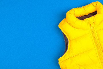 Yellow kids jacket isolated on blue background