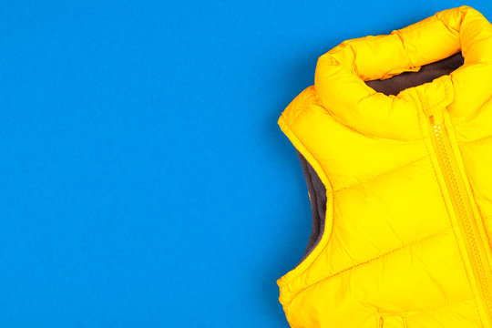 Yellow Kids Jacket Isolated On Blue Background