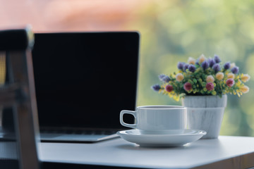 Working desk with laptop computer and a cup of coffee.
