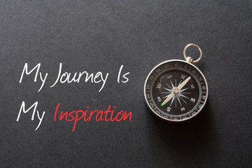 Inspirational quote : My journey is my inspiration ,on black background with compass