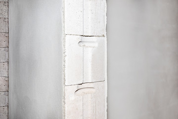 Freshly plastered walls, visible non-plastered bricks in place embedding the door jambs.