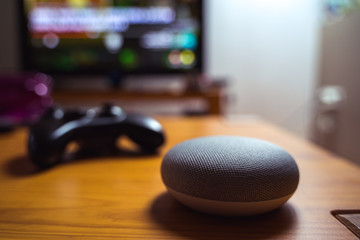 voice controlled smart speaker infront of console gaming system