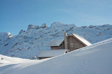 Old house in alpine winter landscape