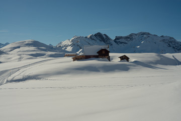 Old house in alpine winter landscape