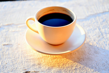 Morning cup of coffee outdoors at dawn.